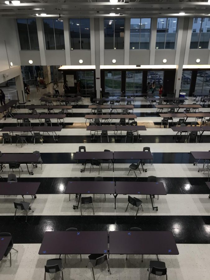 Cafeteria+seats+are+now+marked+for+people+to+sit+in+the+mornings+and+lunches.+The+five+lunches+insure+that+there+are+less+people+in+each+lunch+so+that+students+have+less+contact.+%E2%80%9CIt+is+difficult+for+students+to+find+places+to+sit+with+their+friends+because+there+is+a+five+people+to+a+table+rule.+Especially+as+it+gets+colder+outside+students+are+going+to+find+more+difficulties+finding+tables+for+them+and+their+friends+to+sit+at.%E2%80%9D%2C+sophomore+Julianna+Kuhlman+said.