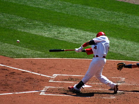 Catcher Yadier Molina swings bat.
