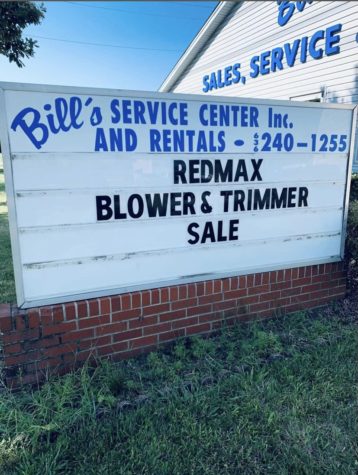 Bills Service Center front sign advertising Redmax sales.