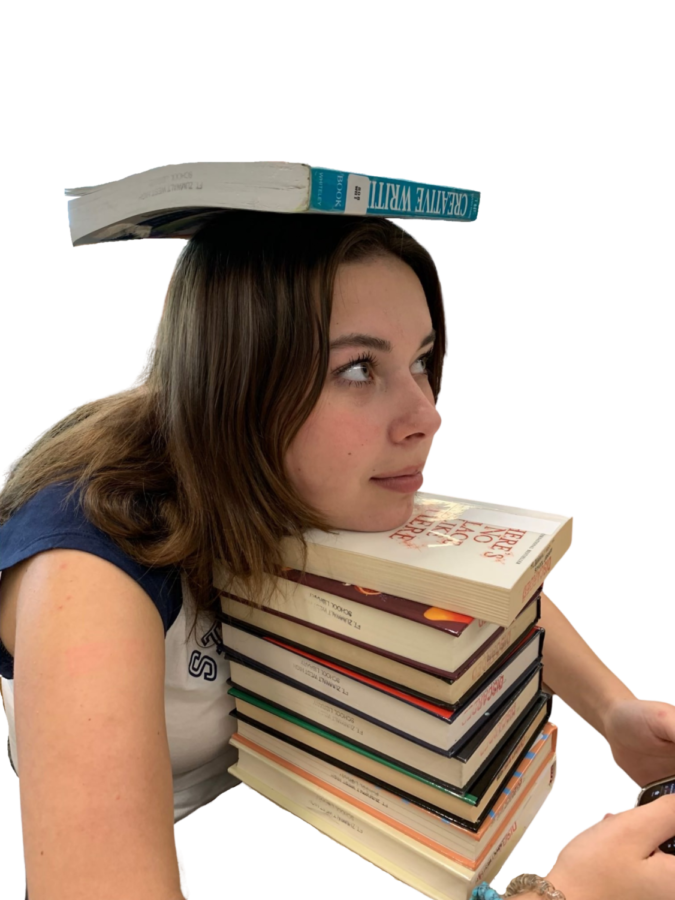 Katelyn Gainer resting head on a stack of books.