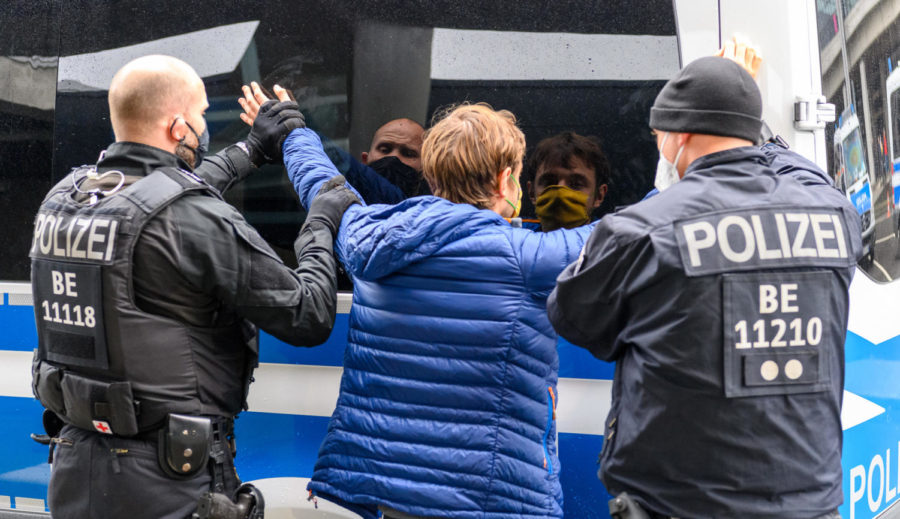A climate change protester is arrested during a blockade of the Berlin airport.