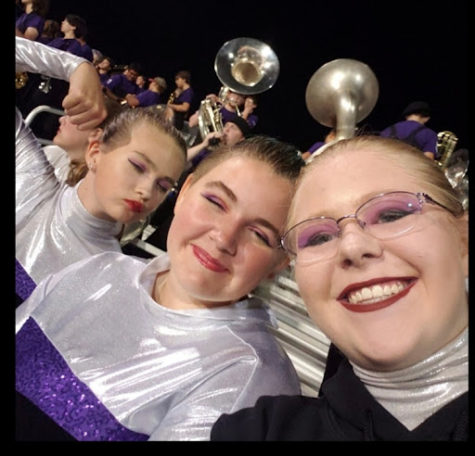 Color guard members goofing around during a football game. The band stays at the game after their performance to hype up the sections and bring some positivity to the game.

 “[There are] people around me that support and understand [me],” freshman Gray Rosemann said (middle).
