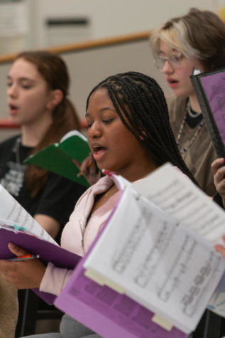 Senior Brynin Henderson joins her fellow singers in a rehearsal for a group number.