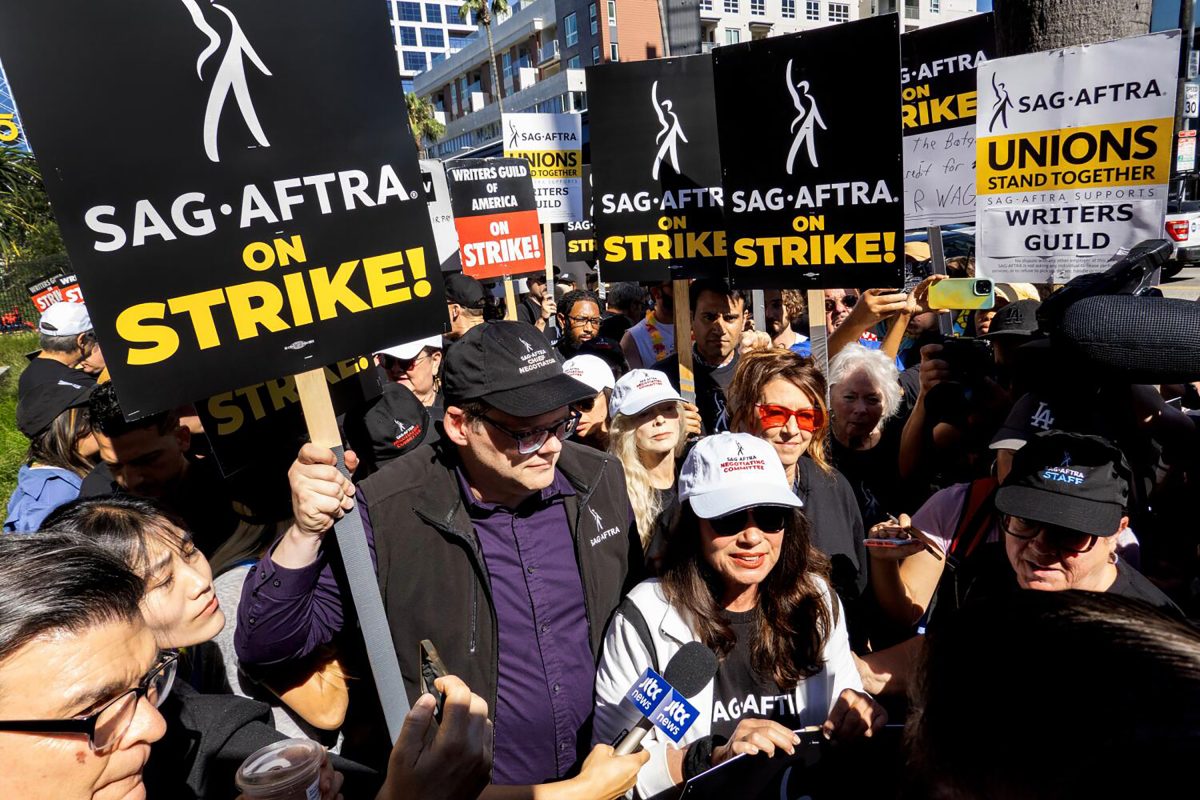LOS ANGELES, CA - JULY 14: SAG-AFTRA President Fran Drescher, white cap front, and National Executive Director and Chief Negotiator Duncan Crabtree-Ireland, left, greet picketers at the Netflix picket line in Los Angeles, CA on Friday, July 14, 2023. Actors join striking writers who have been on the picket lines since the beginning of May.