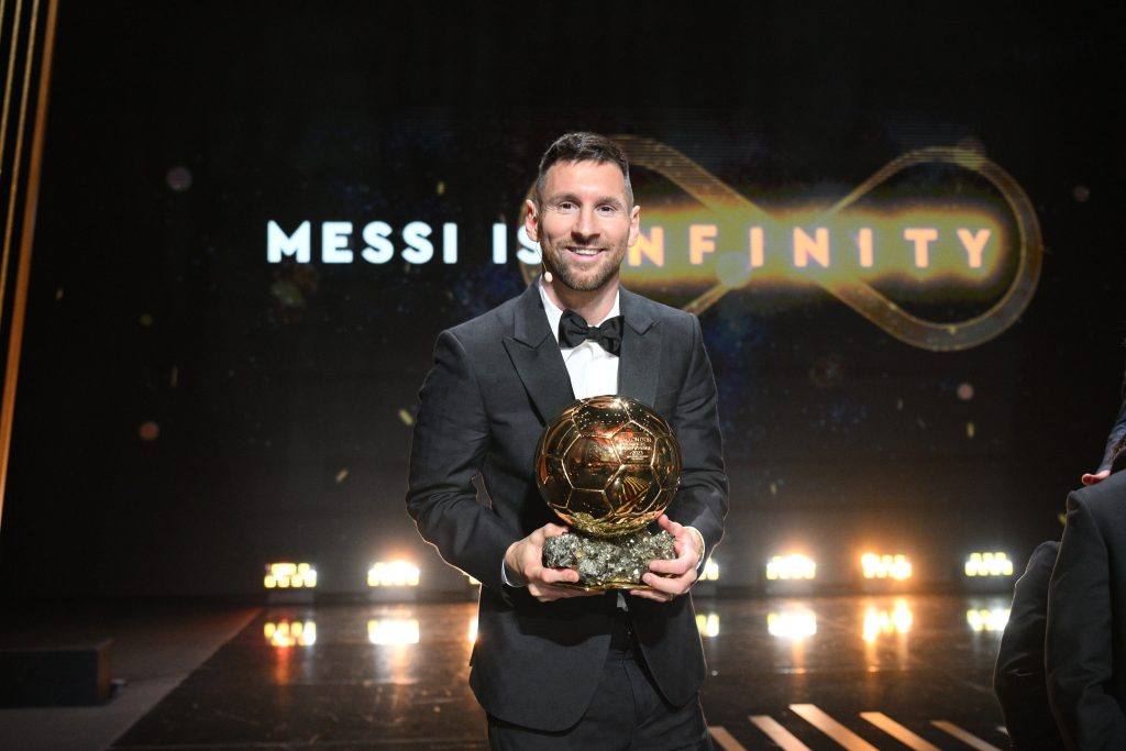 Lionel Messi stands with his 8th Ballon dOr.
