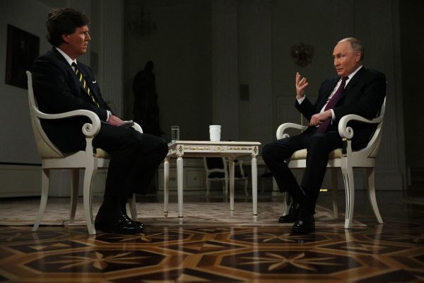 In this pool photograph distributed by Russian state agency Sputnik, Russias President Vladimir Putin gives an interview to US talk show host Tucker Carlson at the Kremlin in Moscow on February 6, 2024. 