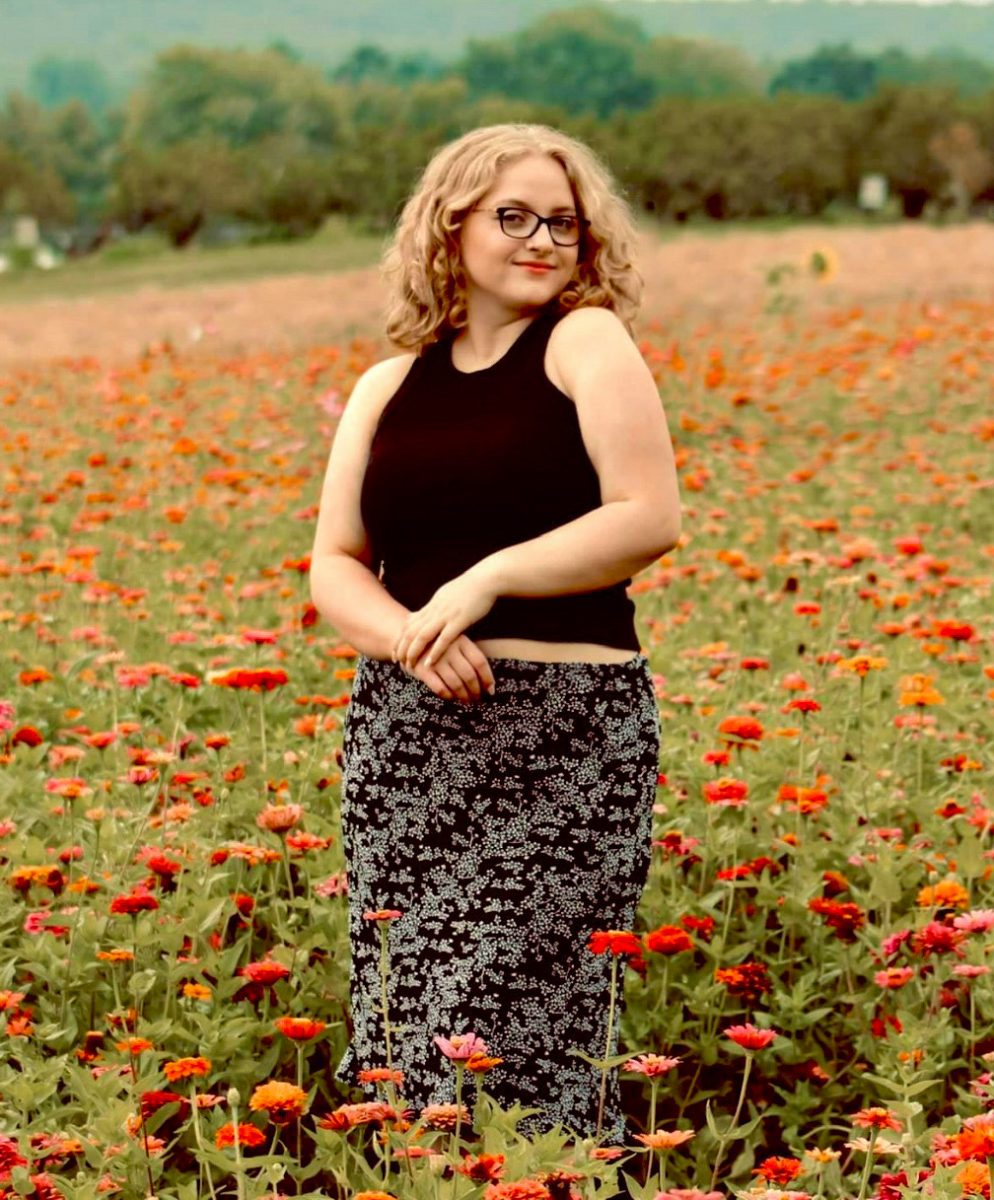 Photo by Kelli Lumma 
Olivia Lumma posing in a field of flowers.