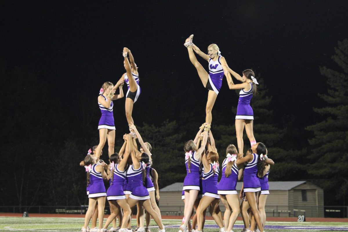 The cheer team performing their routine during halftime